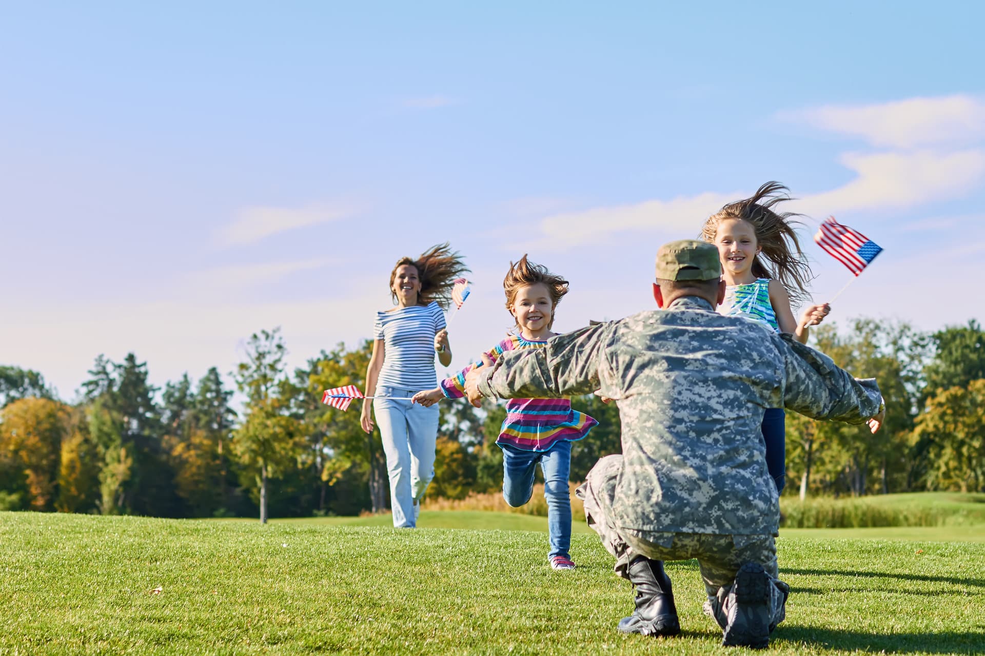 Happy military family in front of their new home