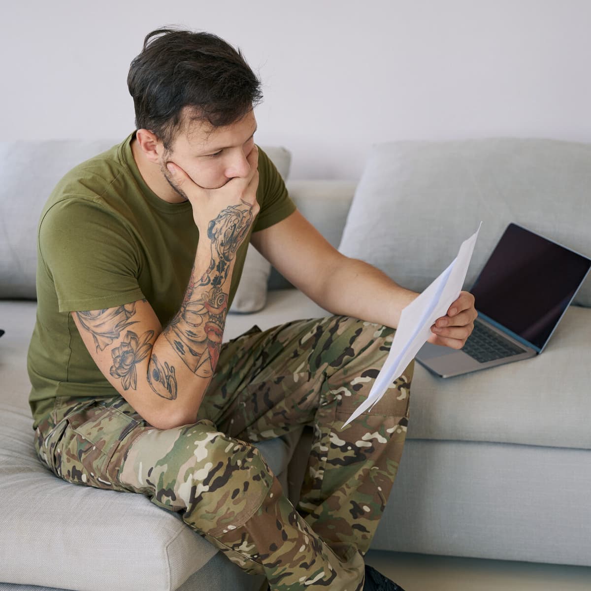 Military service member stressed while reviewing paperwork